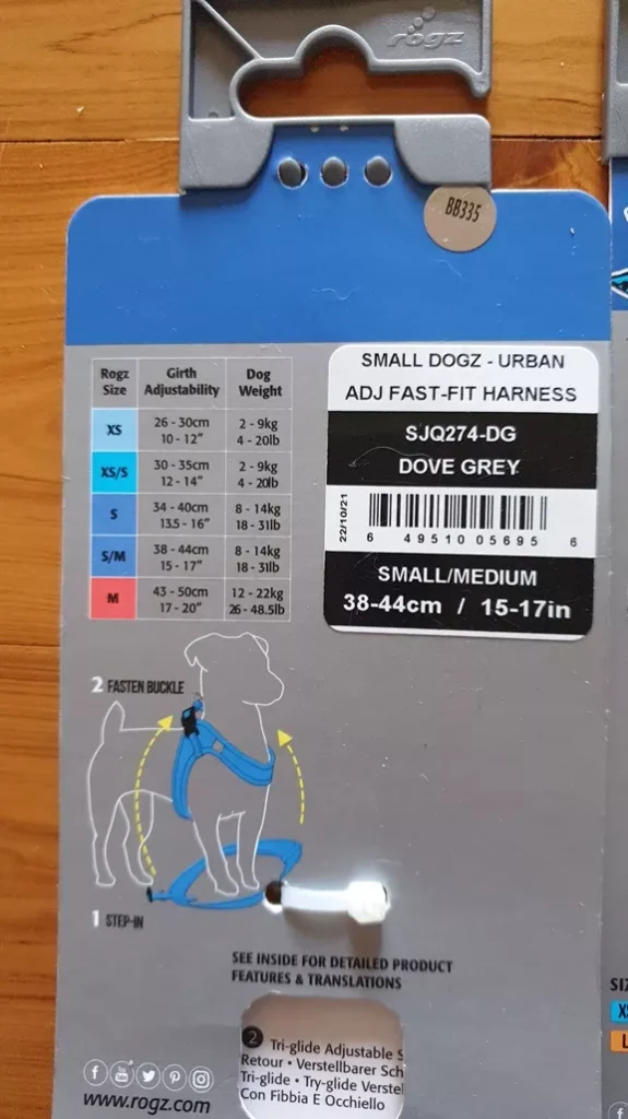 Close-up photograph of the back packaging tag for the Rogz Urban Fast-Fit Harness in Dove Grey, showing the size chart and S/M measurements.