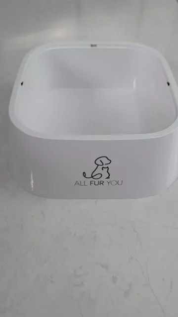 The clean white outer base of the All Fur You dog water bowl without the floating plate, showing the brand logo and side grip cut-outs.