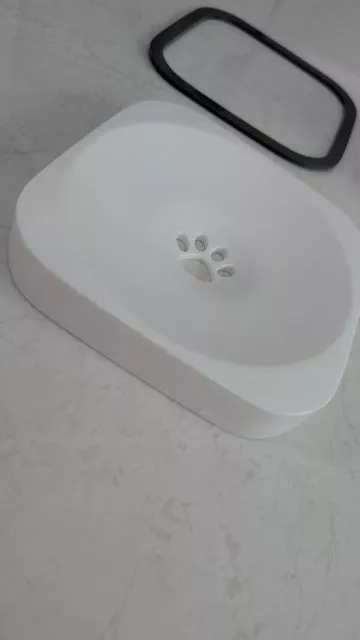 The assembled white floating plate with its central paw drainage design and black outer rim from the All Fur You dog water bowl.